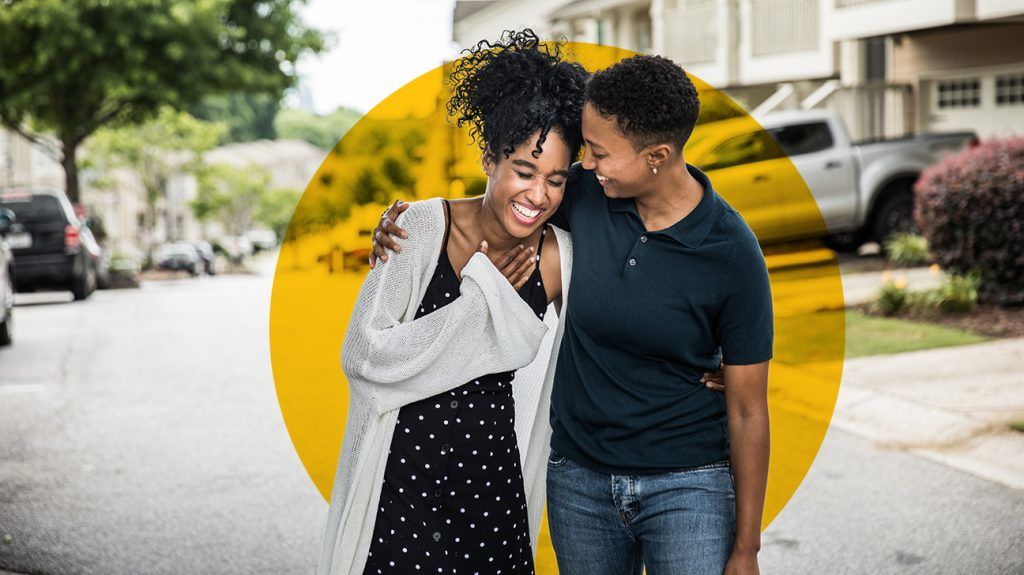 Couple helps eachother to destress and has a good laugh while taking a walk