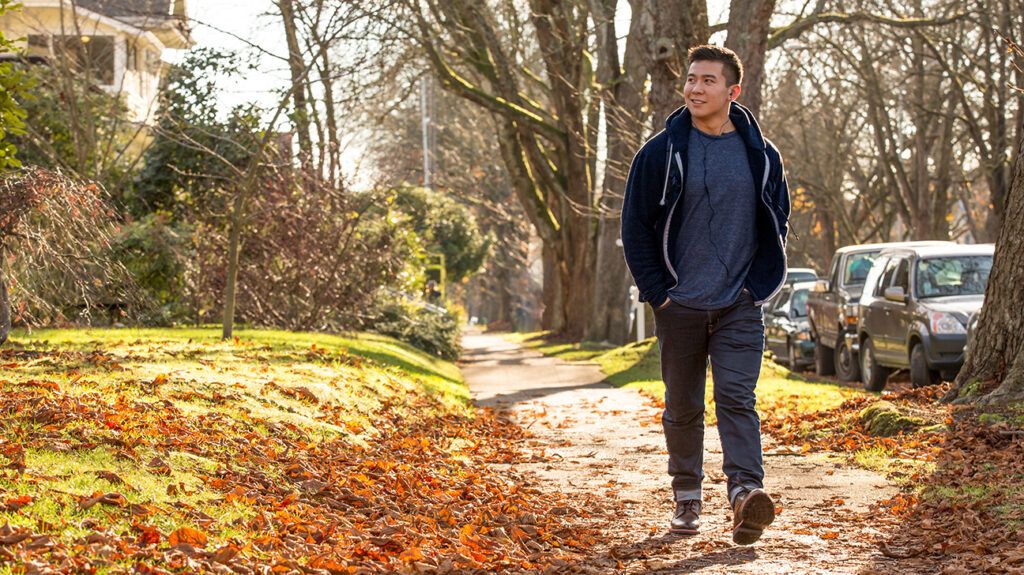 Man taking a walk in a park to counter depression symptoms