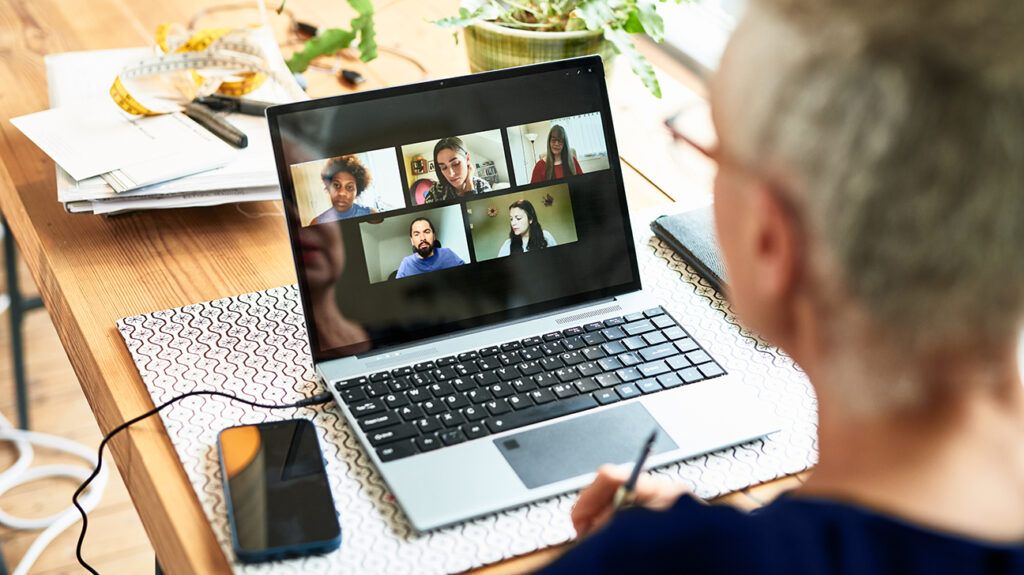 Person sitting at table video conferencing