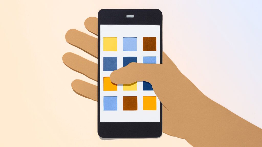 A drawn hand holding a smartphone made out of paper