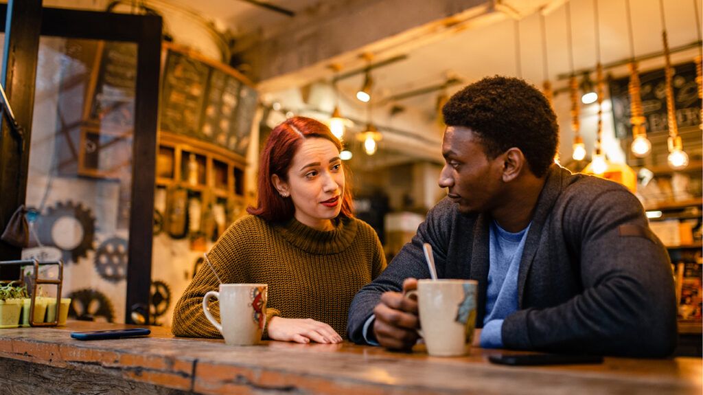 Woman and man talking and drinking coffee